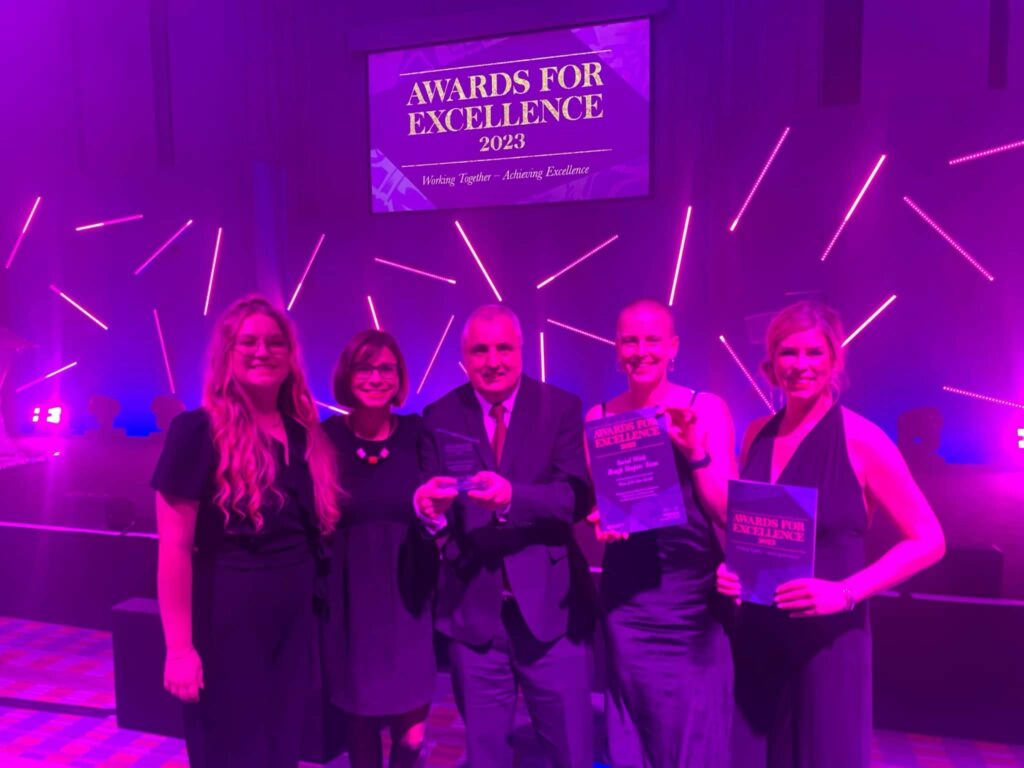 A picture of Ellie Atkins (right) and the Entrenched Rough Sleeper Social Work Team at the Manchester City Council Awards for Excellence 2023 event when they achieved Team of the Year.